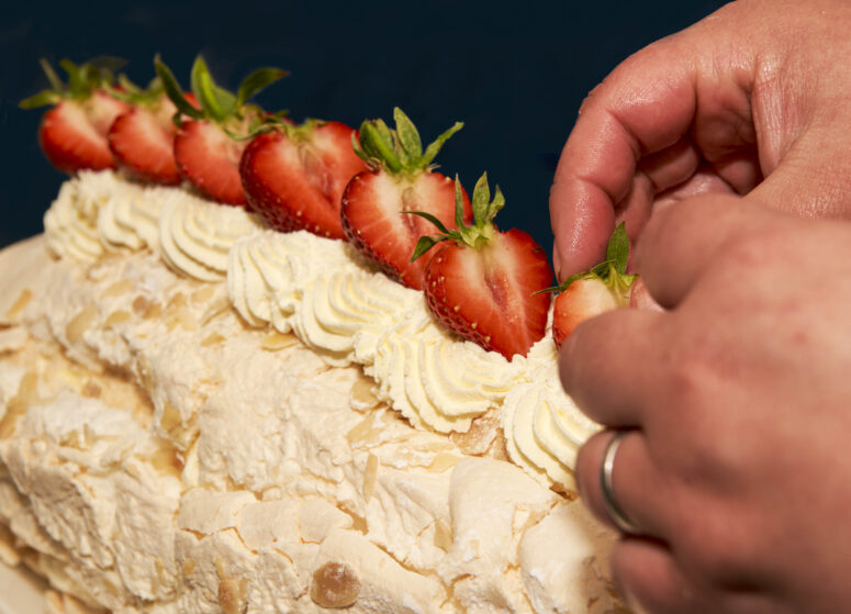 Garnishing a roulade with strawberries