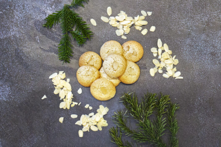 Almond Macaroons surrounded by branches of Christmas tree and flaked almonds